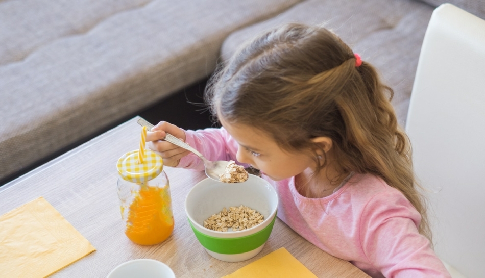 A white girl eats cereal in the morning