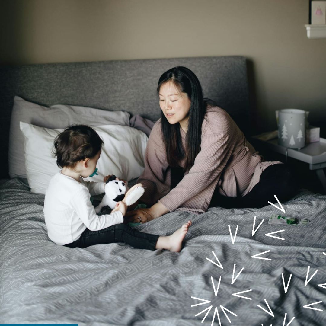 A mom and a young child get ready for bed on the mom's bed